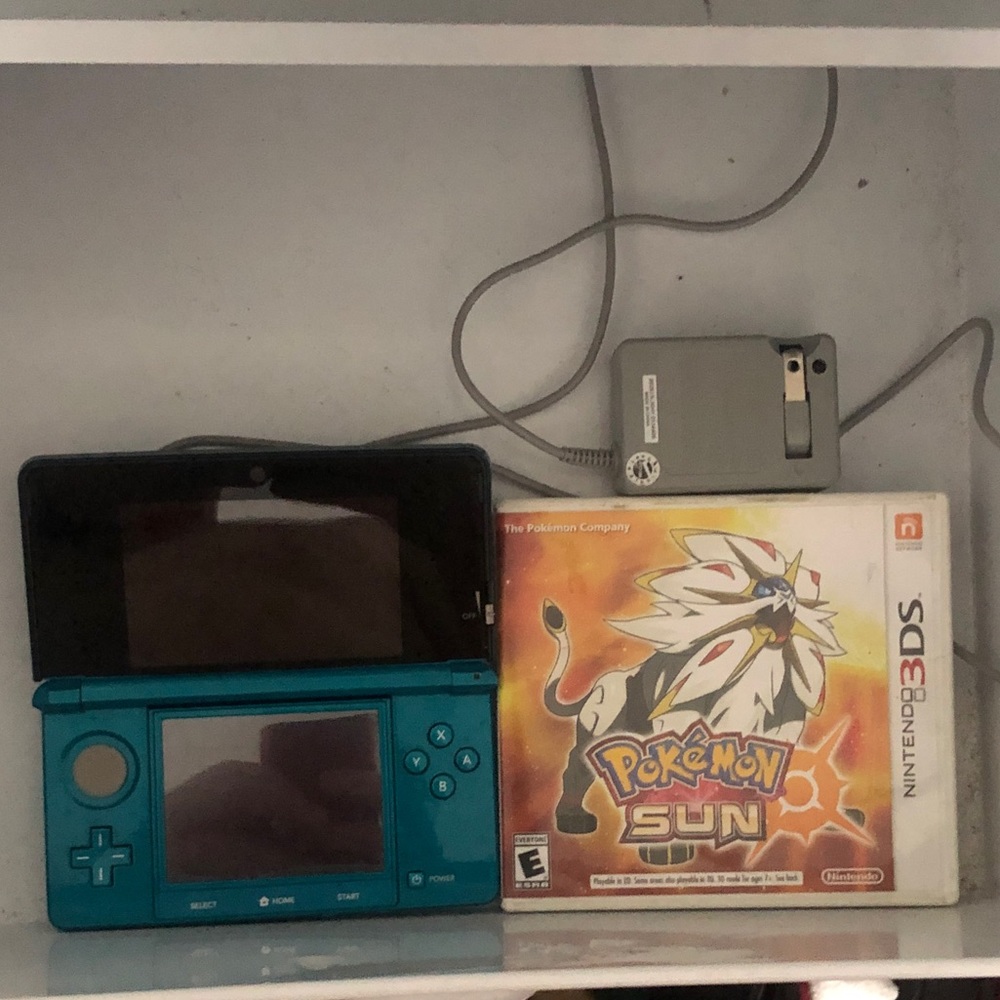 Nintendo 3ds with Pokémon game and charger